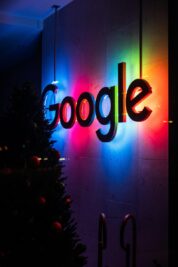 the google logo is lit up at night