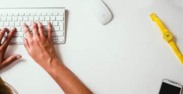 person typing on Apple Cordless Keyboard